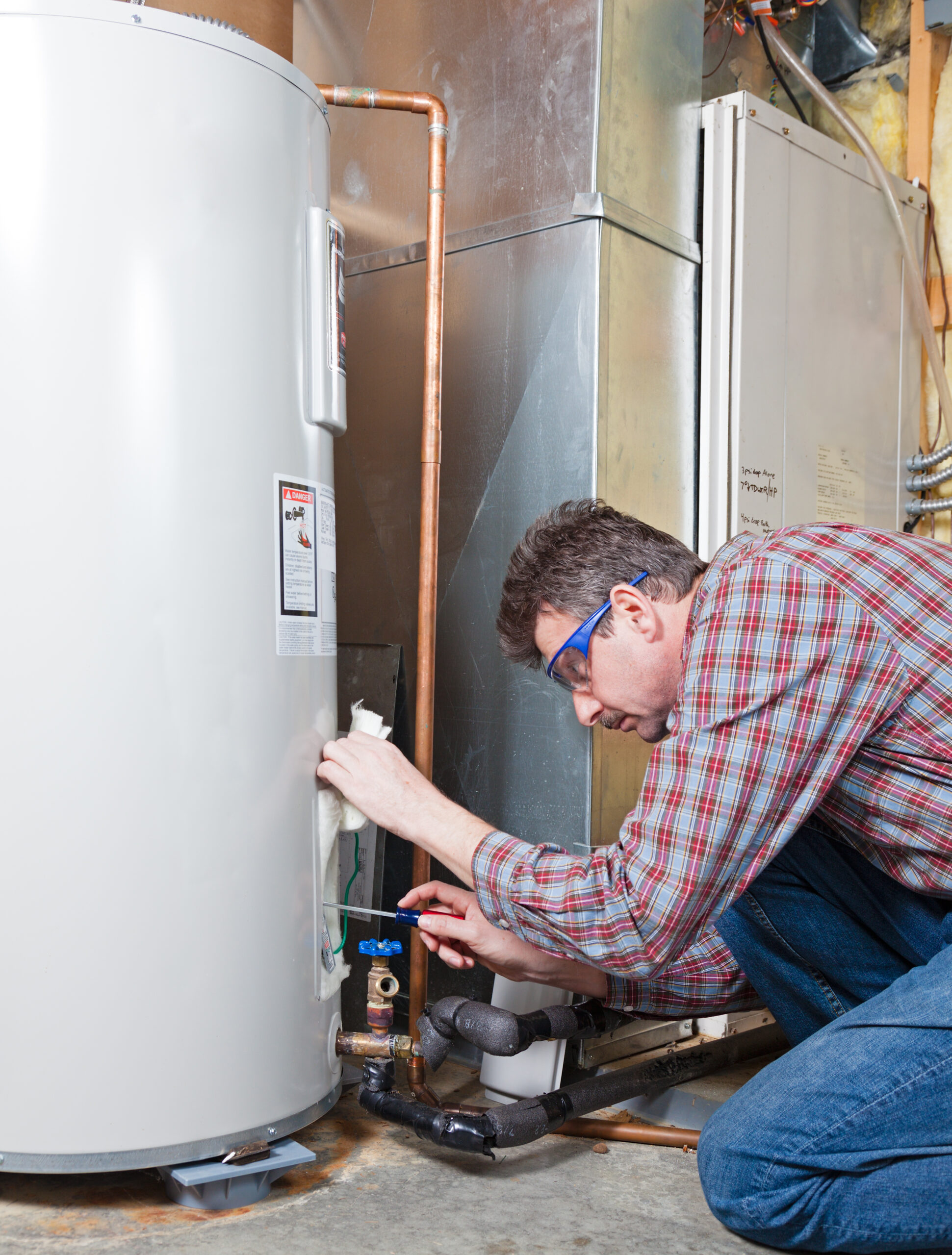 ASAP Rooter & Plumbing technician inspecting a water heater